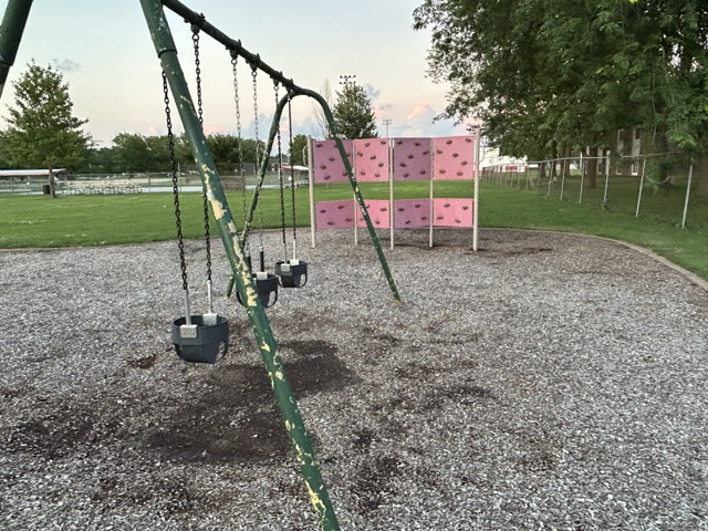 Slater Park in Bourbonnais with slides, swings, and open field, and little league baseball.