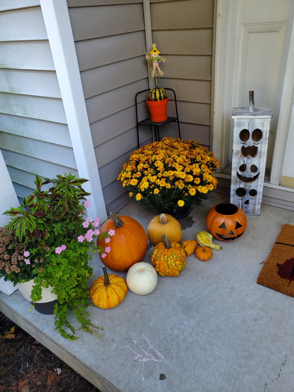 Seasonal fall porch display in Bourbonnais using pumpkins and decor from Benoit Greenhouses.