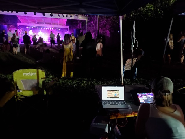 Night view of Kankakee Estival Festival stage from the audio and lighting booth, with a lit stage and crowd in the foreground
