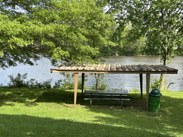 A small pavilion covers a picnic table along the Kankakee River in Momence.