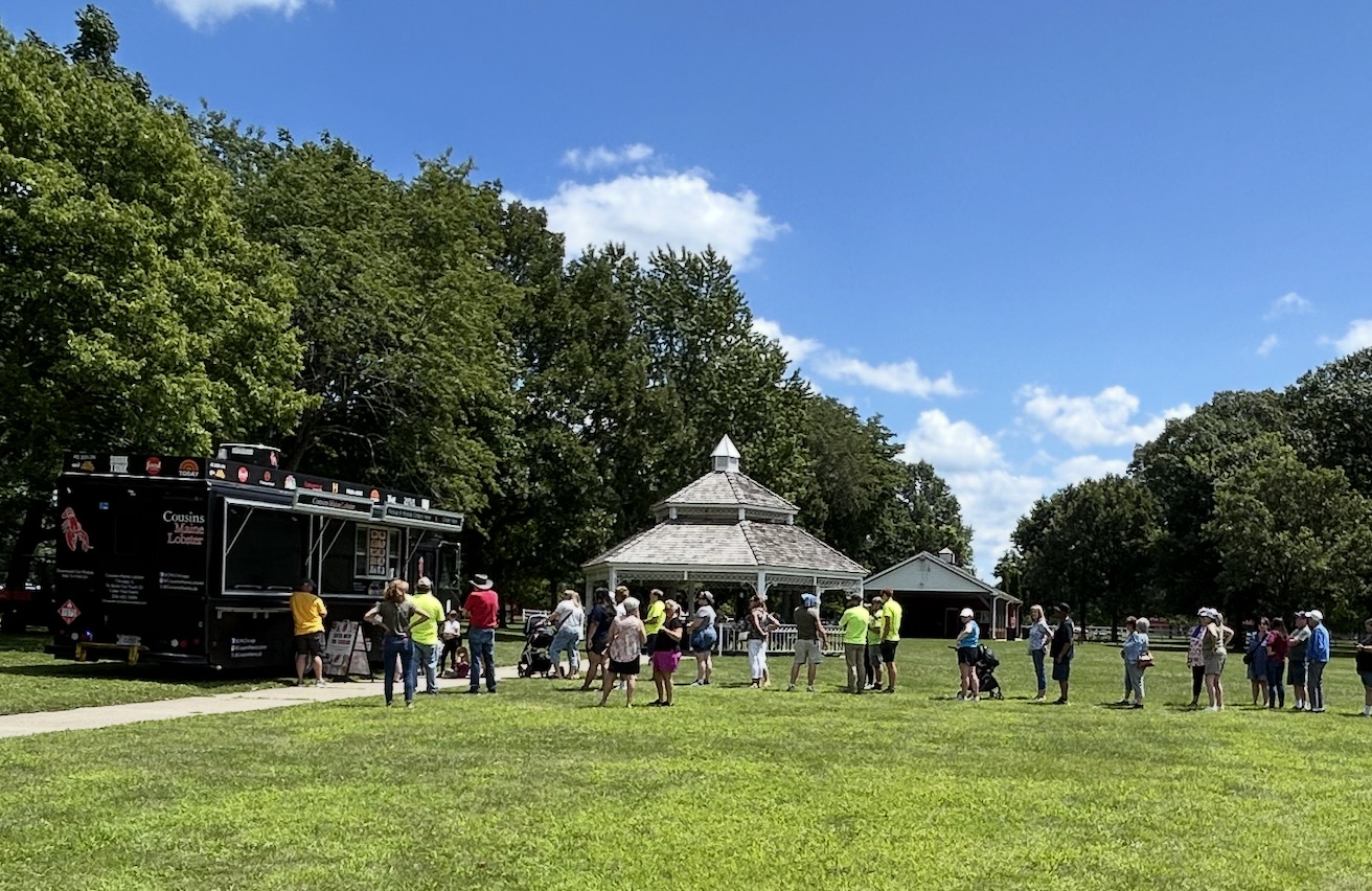Hungry customers wait in line at the Cousins Maine Lobster food truck, parked at Perry Farm in Bradley, Illinois..